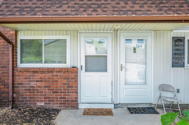 163 Pointe Cir N Unit 163, Coram, NY 11727 - view of exterior entry with a shingled roof and brick siding