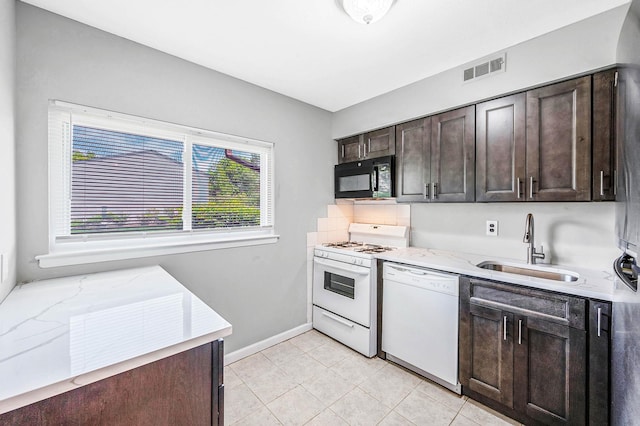 163 Pointe Cir N Unit 163, Coram, NY 11727 - kitchen with white appliances, a sink, dark brown cabinets, baseboards, and light stone counters