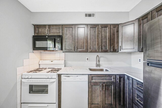 163 Pointe Cir N Unit 163, Coram, NY 11727 - kitchen with white appliances, a sink, dark brown cabinets, and light stone countertops