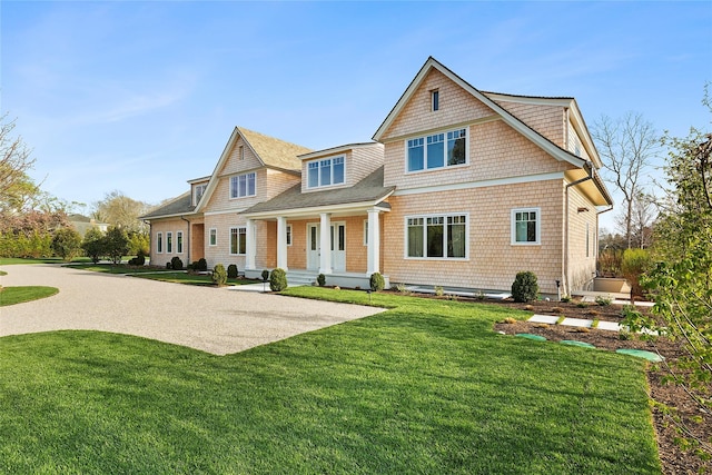 171 Oneck Ln, Westhampton Beach, NY 11978 - view of front facade featuring a front lawn, a shingled roof, and covered porch