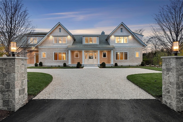 171 Oneck Ln, Westhampton Beach, NY 11978 - shingle-style home featuring a porch, a shingled roof, and curved driveway