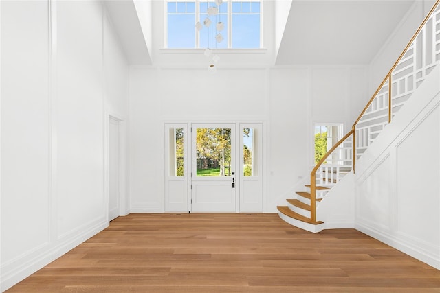171 Oneck Ln, Westhampton Beach, NY 11978 - entryway with stairway, a wealth of natural light, and a decorative wall
