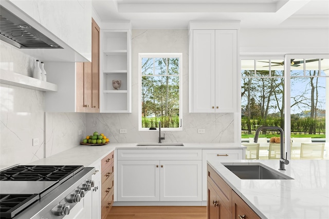 171 Oneck Ln, Westhampton Beach, NY 11978 - kitchen featuring open shelves, backsplash, light stone counters, and a sink