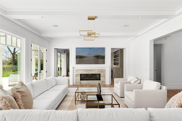 171 Oneck Ln, Westhampton Beach, NY 11978 - living room featuring beamed ceiling, a high end fireplace, light wood-style floors, ornamental molding, and recessed lighting