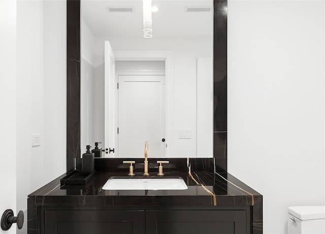 171 Oneck Ln, Westhampton Beach, NY 11978 - bathroom with vanity, toilet, and visible vents