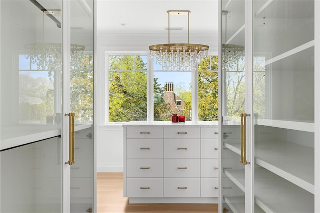 171 Oneck Ln, Westhampton Beach, NY 11978 - spacious closet with a chandelier, light wood-type flooring, and visible vents