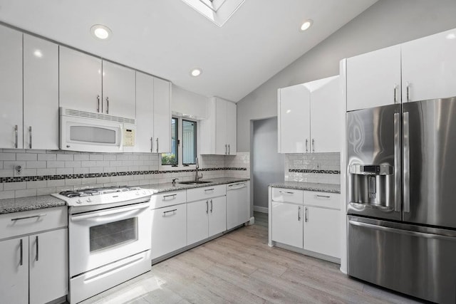 214 Central Park Rd, Plainview, NY 11803 - kitchen with white appliances, a sink, lofted ceiling, white cabinets, and backsplash