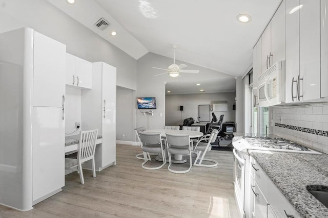 214 Central Park Rd, Plainview, NY 11803 - kitchen with white appliances, a ceiling fan, light wood finished floors, vaulted ceiling, and white cabinets