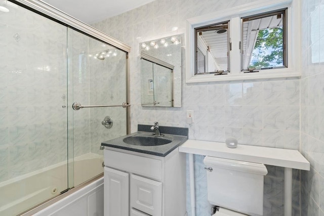 214 Central Park Rd, Plainview, NY 11803 - full bath featuring tile walls, toilet, bath / shower combo with glass door, vanity, and tasteful backsplash