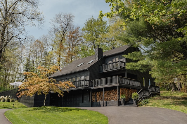 825 County Route 6, High Falls, NY 12440 - view of front facade with a balcony, a chimney, an attached garage, driveway, and a front yard
