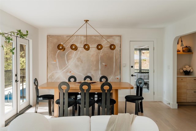 825 County Route 6, High Falls, NY 12440 - dining room with light wood-type flooring, arched walkways, and baseboards