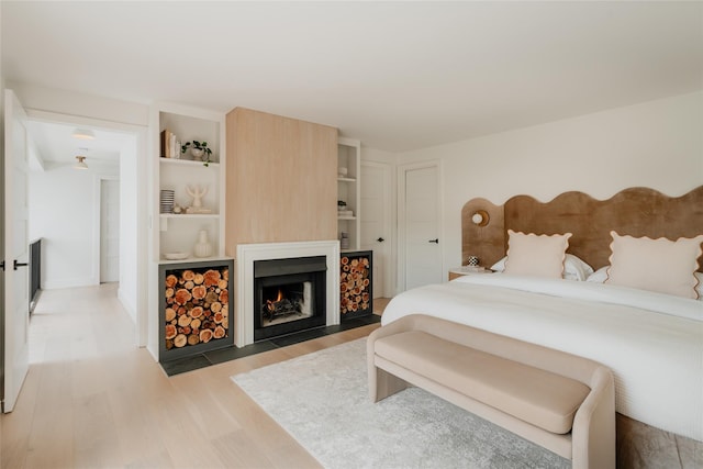 825 County Route 6, High Falls, NY 12440 - bedroom with wood finished floors and a fireplace with flush hearth