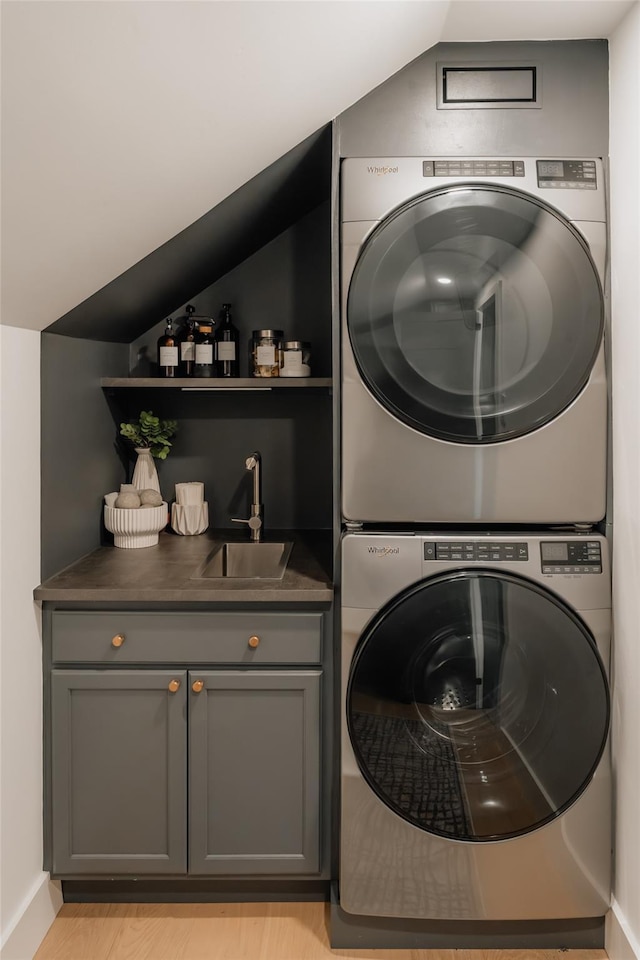 825 County Route 6, High Falls, NY 12440 - laundry area featuring stacked washer and clothes dryer, wet bar, cabinet space, and baseboards