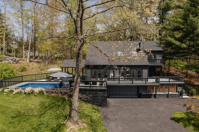 825 County Route 6, High Falls, NY 12440 - view of front facade with a deck, stairway, an attached garage, and asphalt driveway