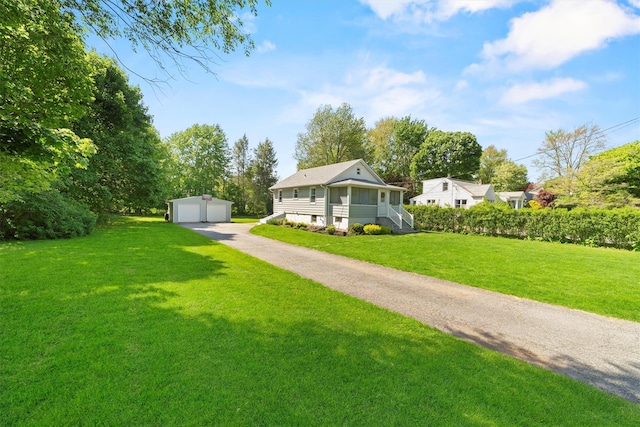 view of front of property featuring a garage, an outdoor structure, and a front yard