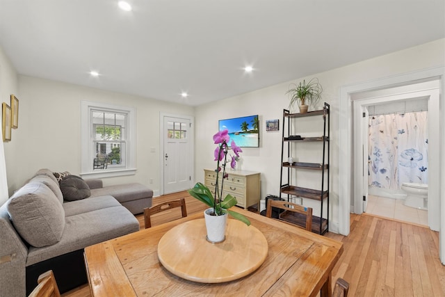 living room with light wood-type flooring and recessed lighting