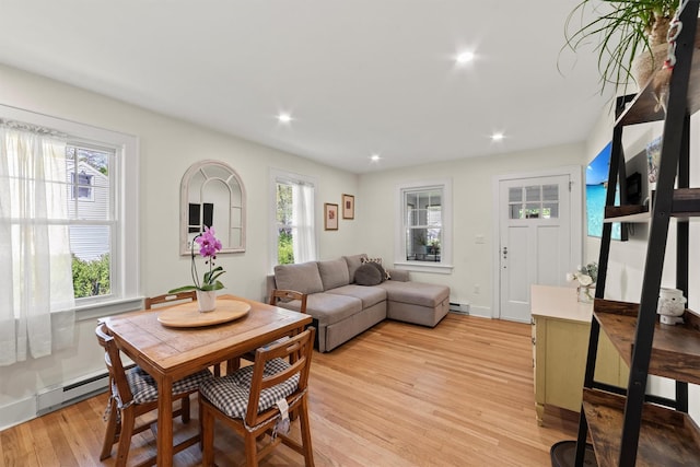 dining area featuring light wood-type flooring, recessed lighting, and baseboard heating