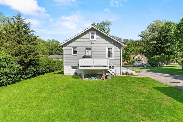 rear view of house featuring a yard