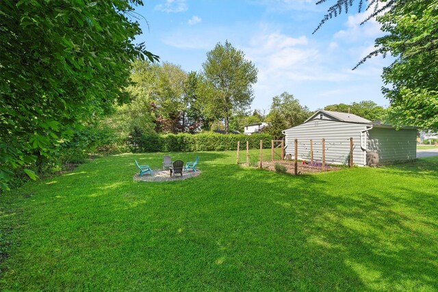 view of grassy yard with a fire pit