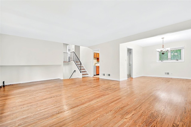 22 Chauncey St, Tuckahoe, NY 10707 - unfurnished living room with a chandelier, light wood-style flooring, stairway, and baseboards