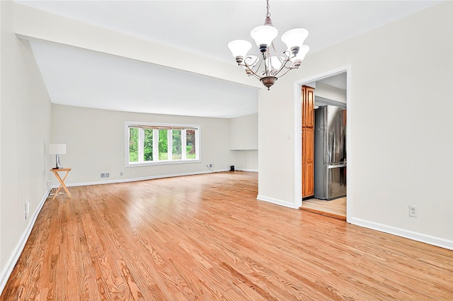 22 Chauncey St, Tuckahoe, NY 10707 - spare room featuring a chandelier, light wood-style flooring, and baseboards