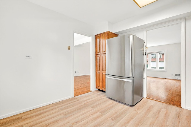 22 Chauncey St, Tuckahoe, NY 10707 - kitchen with freestanding refrigerator, light wood finished floors, brown cabinets, and baseboards