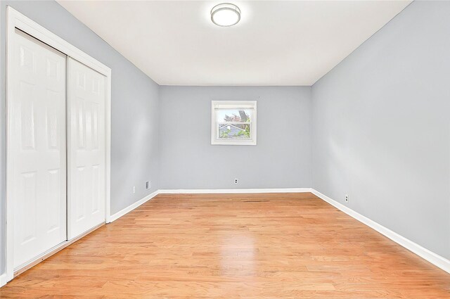 22 Chauncey St, Tuckahoe, NY 10707 - unfurnished bedroom with baseboards, light wood-type flooring, and a closet