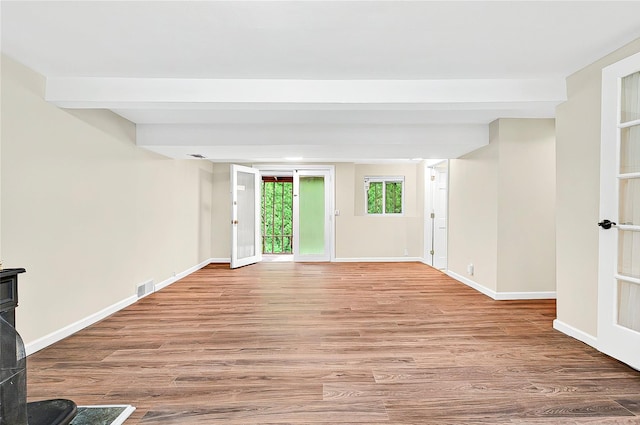 22 Chauncey St, Tuckahoe, NY 10707 - unfurnished living room featuring wood finished floors, baseboards, and a wood stove