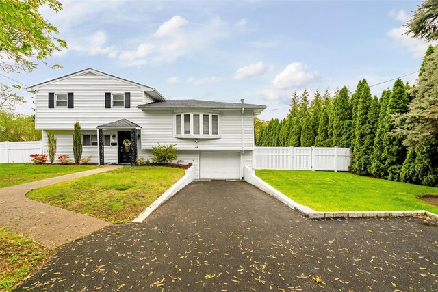 22 Chauncey St, Tuckahoe, NY 10707 - split level home featuring a garage and asphalt driveway