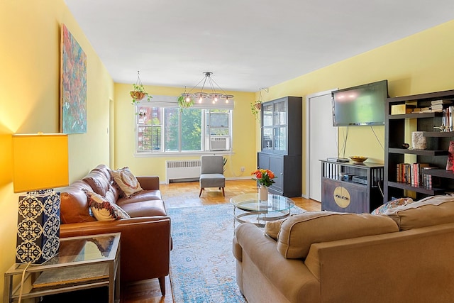 living area with cooling unit, baseboards, and radiator heating unit