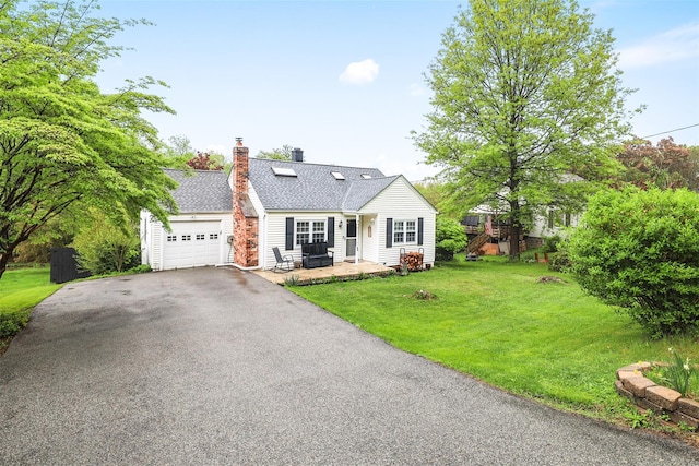 46 Quaker Hill Rd, Monroe, NY 10950 - view of front facade with roof with shingles, driveway, a garage, a front lawn, and a chimney