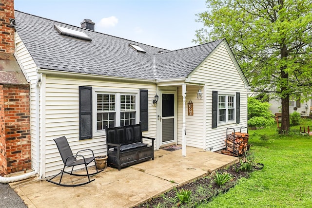 46 Quaker Hill Rd, Monroe, NY 10950 - rear view of property featuring a yard, a shingled roof, and a chimney