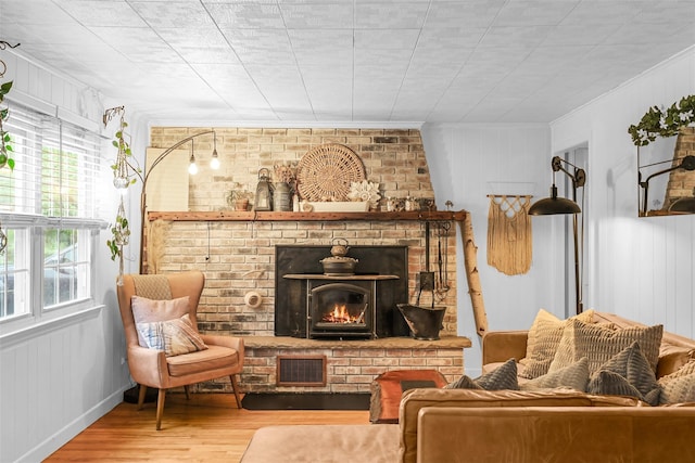 46 Quaker Hill Rd, Monroe, NY 10950 - living room featuring ornamental molding, visible vents, a brick fireplace, and wood finished floors