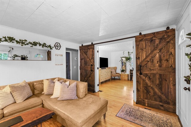 46 Quaker Hill Rd, Monroe, NY 10950 - living area with a barn door, light wood-style flooring, and ornamental molding