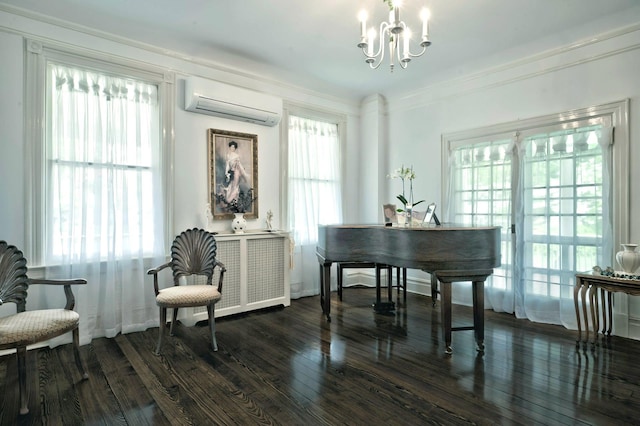 sitting room featuring a wall mounted AC, a chandelier, wood finished floors, healthy amount of natural light, and crown molding