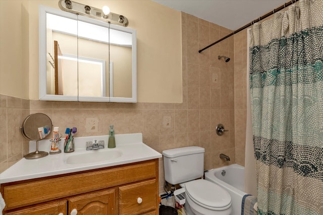 bathroom featuring tile walls, toilet, shower / tub combo with curtain, and vanity