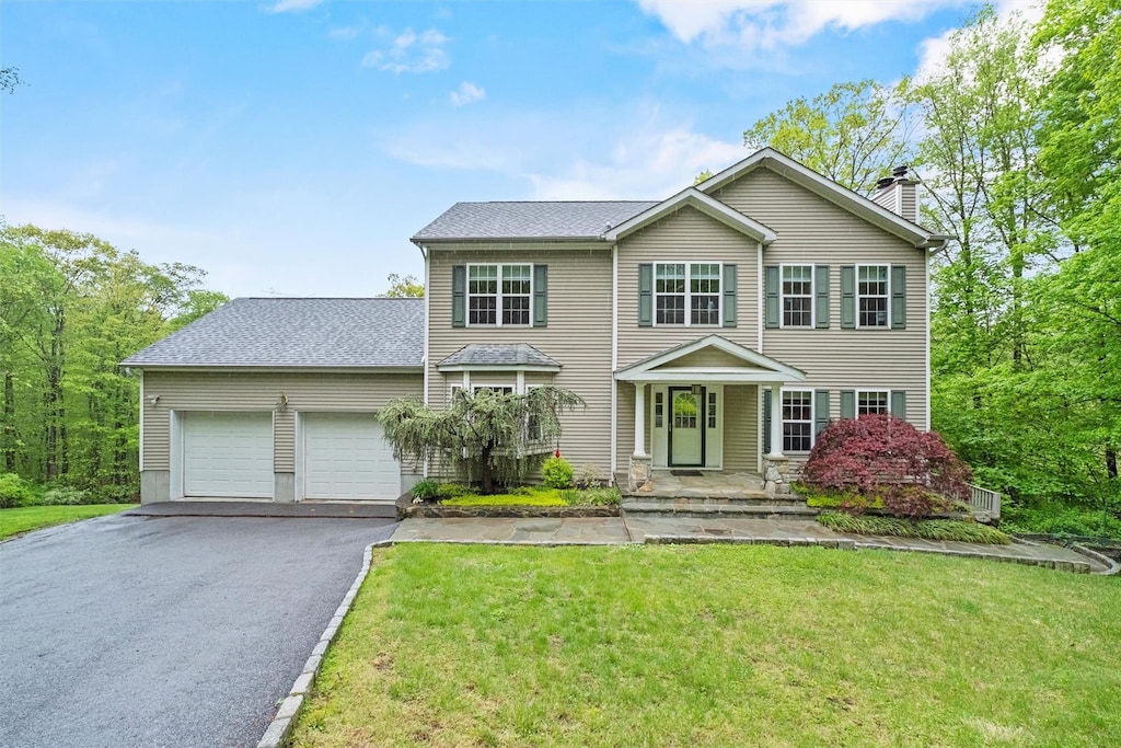 218 Hessian Hills Rd, Croton-On-Hudson, NY 10520 - view of front of property featuring asphalt driveway, an attached garage, a chimney, and a front lawn