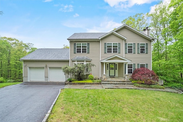 218 Hessian Hills Rd, Croton-On-Hudson, NY 10520 - view of front of property featuring asphalt driveway, an attached garage, a chimney, and a front lawn