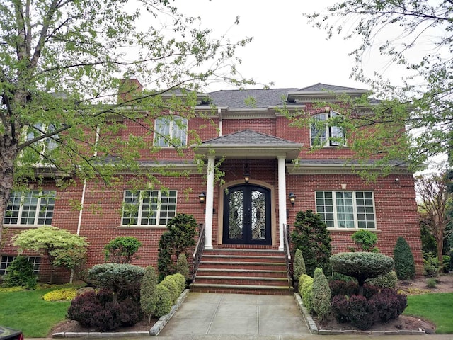 view of front of property featuring french doors and brick siding