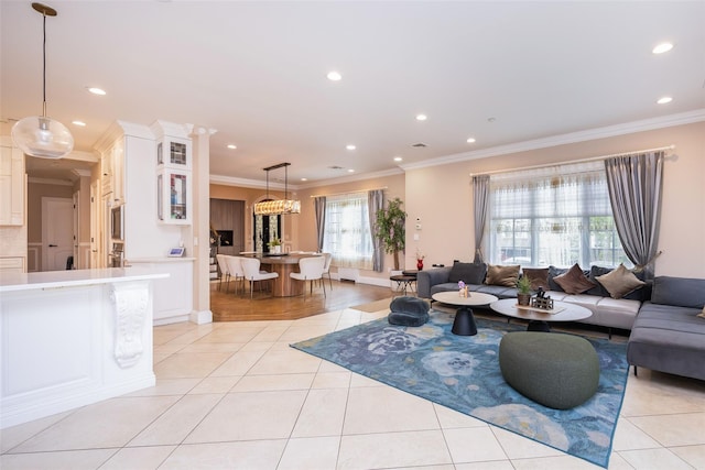 living room with ornamental molding, light tile patterned floors, recessed lighting, and baseboards