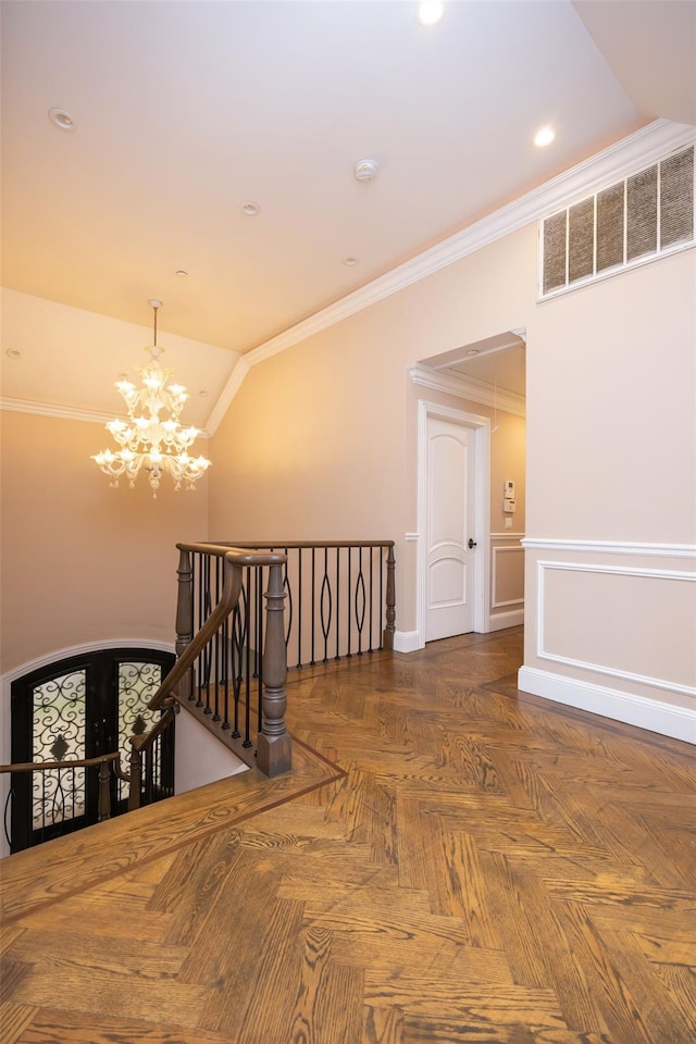 hall with an upstairs landing, a chandelier, ornamental molding, vaulted ceiling, and recessed lighting