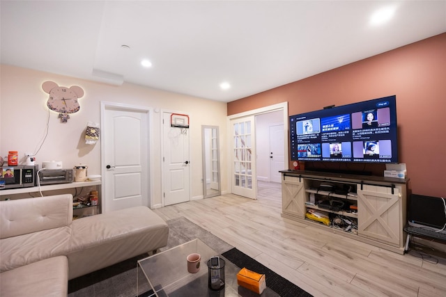 living room featuring light wood-type flooring and recessed lighting