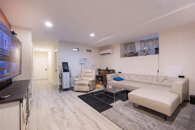 living room featuring an AC wall unit, light wood finished floors, and recessed lighting