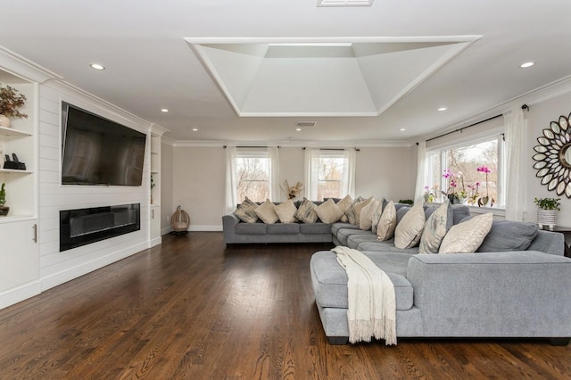 living area featuring a large fireplace, crown molding, dark wood-type flooring, and recessed lighting