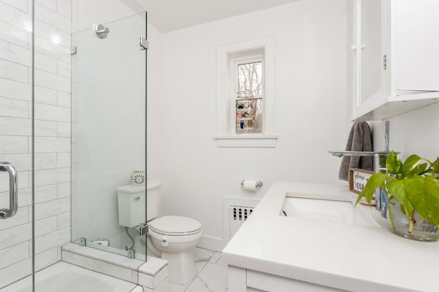 bathroom featuring toilet, marble finish floor, and radiator