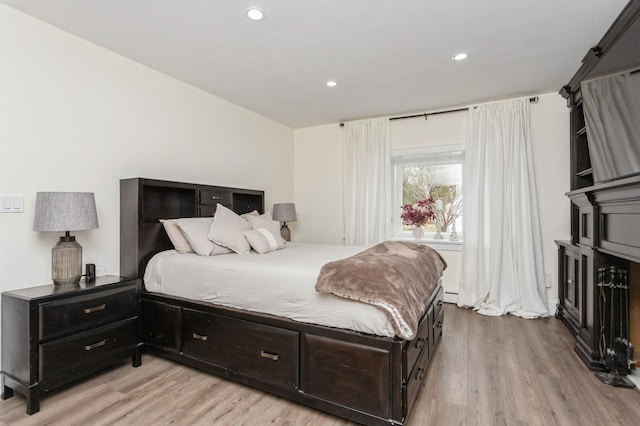 bedroom with recessed lighting and light wood-type flooring