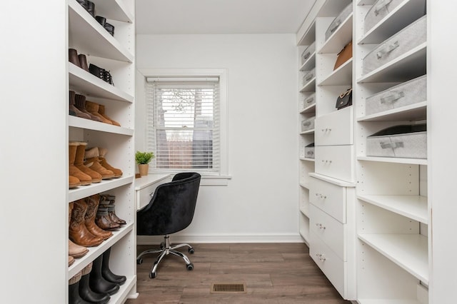 office space with baseboards, dark wood-type flooring, and visible vents