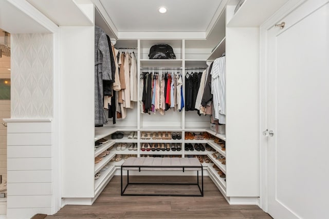 walk in closet with wood finished floors