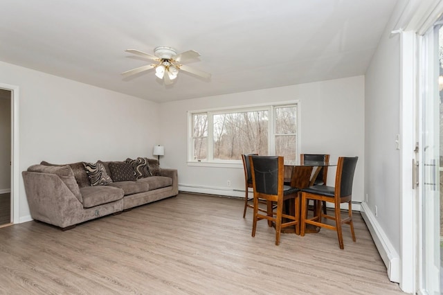 interior space featuring a wealth of natural light, light wood-style flooring, and a baseboard radiator