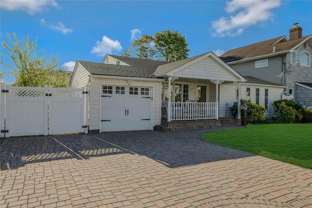 311 Atlantic, Massapequa Park, NY 11762 - view of front of property with a porch, a garage, a gate, decorative driveway, and a shingled roof